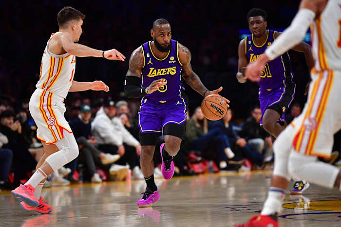 Lakers forward LeBron James dribbles the ball up the court against the Hawks.